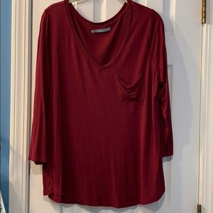 Three-quarter sleeve, v-neck top with pocket.